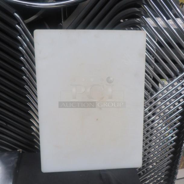 White 20x15 cutting board, lightly used, showing minor stains. Appears durable with smooth surface. Model: 2XBID.