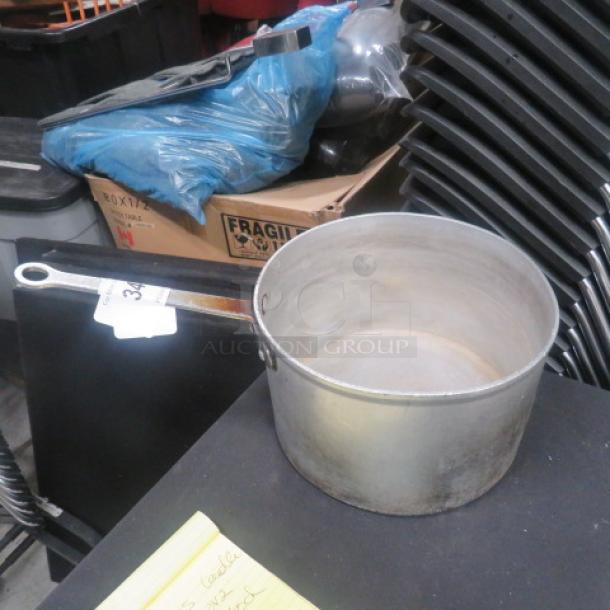 Vollrath aluminum sauce pan with handle, showing signs of use. Auction tag attached, indicating item number.