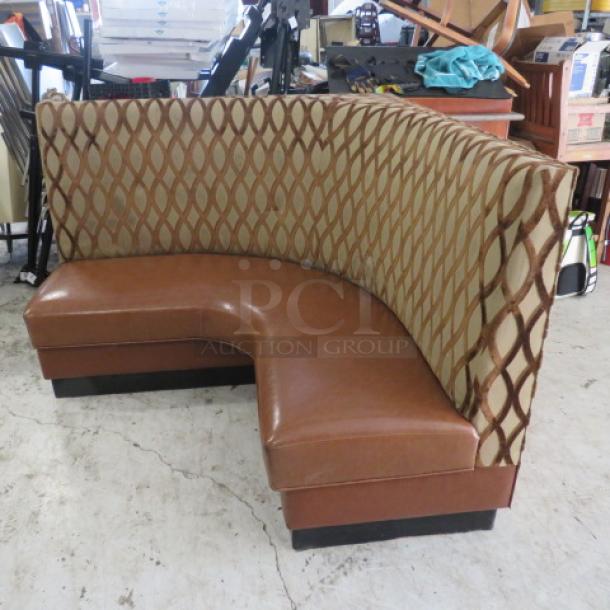 Brown cushioned corner booth, 59"x27"x42", features patterned back, leather-like seat, excellent condition.