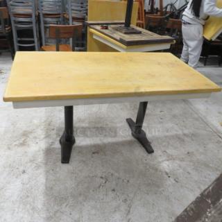 Wooden tabletop on dual pedestal base, 60x32x30 inches. Gently used, sturdy design, light wood finish.