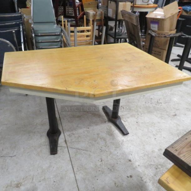 Wooden corner table with dual pedestal base, 57x42x30 inches. Features a slightly worn finish, ideal for versatile use.