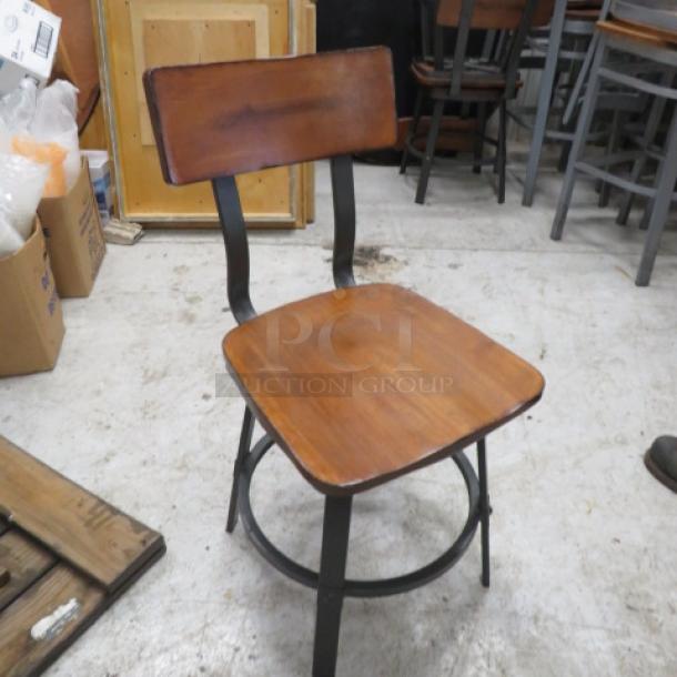Industrial black metal chair with wooden seat and back. Good condition. Ideal for vintage or modern decor.