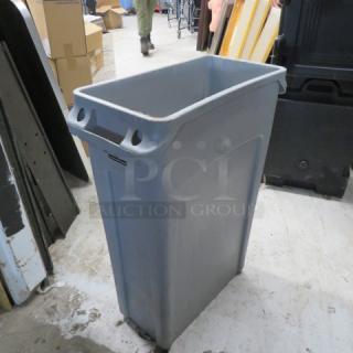 Rubbermaid Slim Jim trash can, gray, in used condition. Rectangular shape with molded handles, suitable for commercial use.