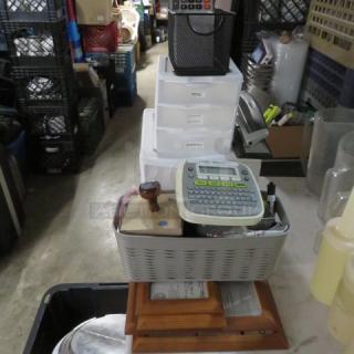 One lot of assorted office supplies, including a label maker, wooden photo frames, storage bins, and a black mesh organizer.
