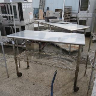 Stainless steel table with Metro under shelf on casters, 49.5x24x37 inches, used condition, ideal for kitchen or workshop use.