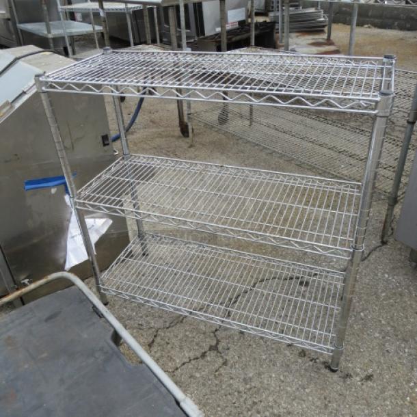 Chrome Metro shelf unit with 3 adjustable shelves, dimensions 36x14x35 inches. Good condition with minor wear. Ideal for storage.