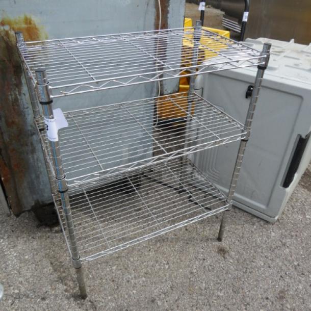 Three-tier Metro shelf, chrome finish, 24"x14"x30", sturdy wire construction, minimal wear, suitable for storage.