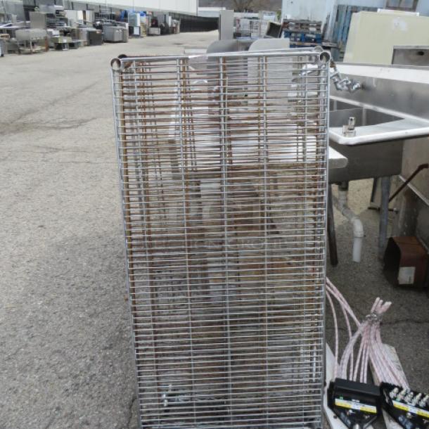 Silver Metro shelf, 48x24 inches, visible wear. Ideal for storage, durable construction. Appears used, suitable for commercial use.