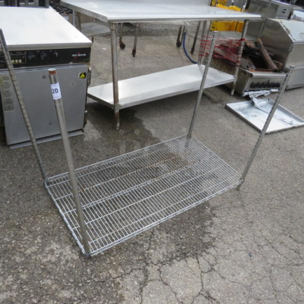 Chrome-finished Metro shelf with four vertical poles, dimensions 48x24x36 inches, in used condition showing slight rust.