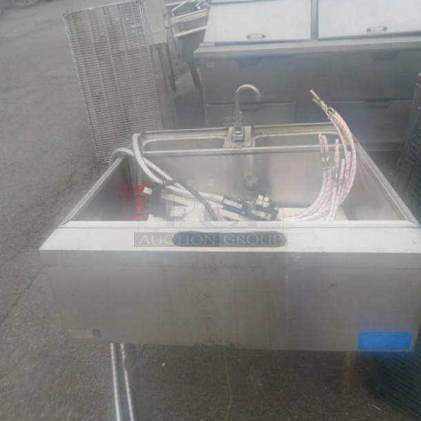 Stainless steel under bar ice well with 2 Wunderbar guns and dual hand sink with faucet, moderate wear.