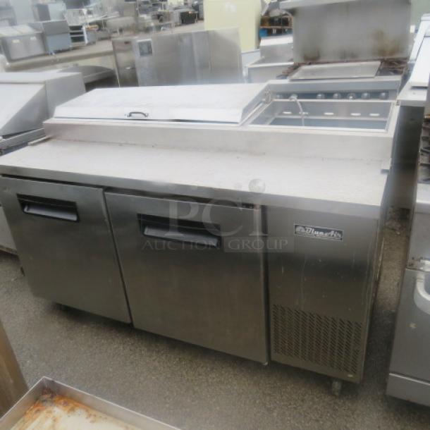 One Blue Air 2-Door Refrigerated Prep Table, Model BAPP67, 67x32x43, 115V, on casters, missing one lid, includes two racks.