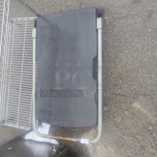 Rubbermaid dolly with metal frame and black platform, used condition, visible wear on the platform.