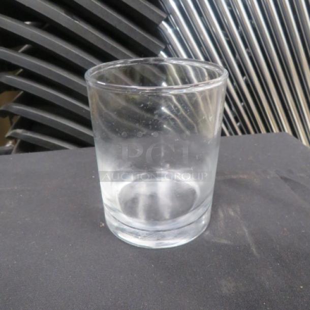 Clear rocks glass, cylindrical shape, good condition, no visible markings. Suitable for serving beverages.
