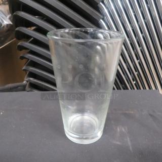 16oz clear beer glass with a tapered design, in good condition, no visible markings.