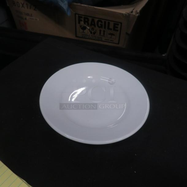New Superior 7-inch white plate, item #7353121, pristine condition, displayed on a black background.