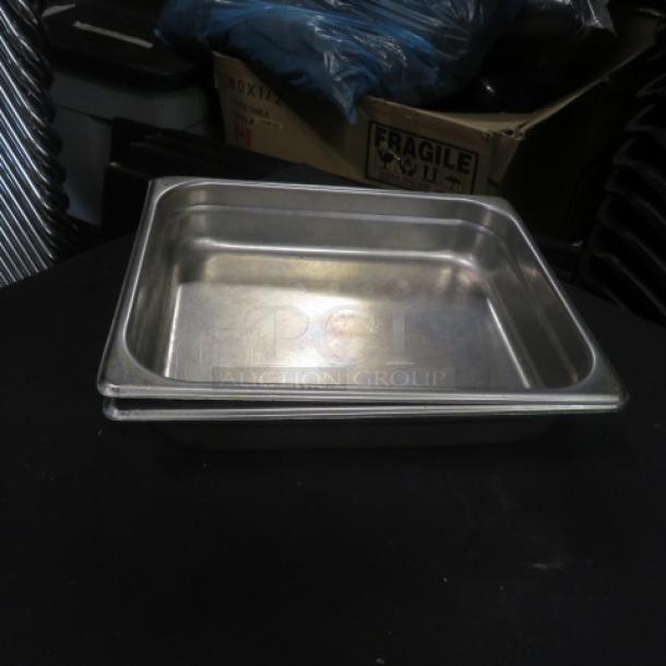 1/2 size 2.5-inch deep hotel pan, stainless steel, used condition. Suitable for catering or food service use.