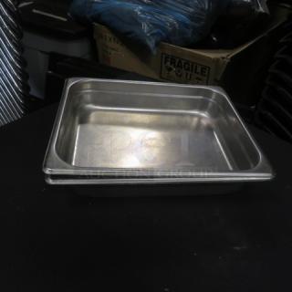 1/2 size 2.5-inch deep hotel pan, stainless steel, used condition. Suitable for catering or food service use.