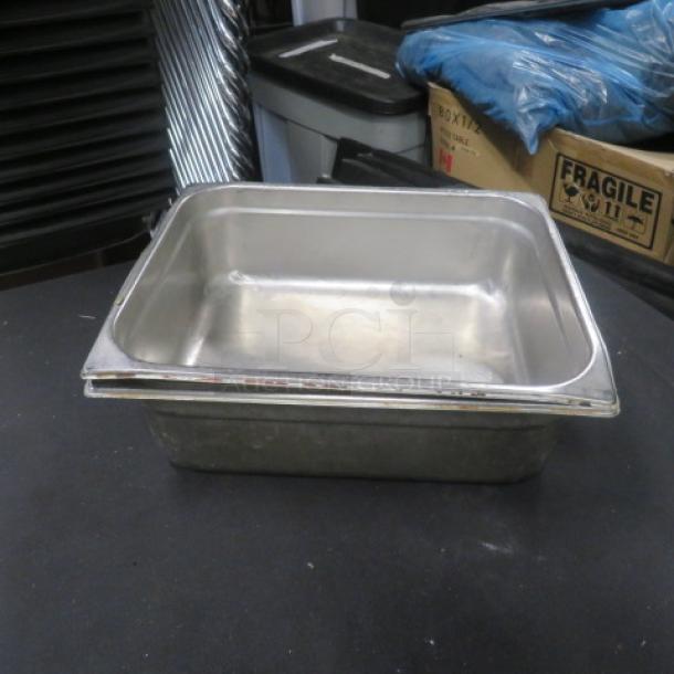 1/2 Size 4 Inch Deep Hotel Pan, stainless steel, used condition, appearing clean and intact, suitable for catering use.