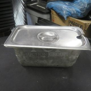 One 1/3 size, 6-inch deep hotel pan with lid, made of stainless steel, used condition, with visible wear marks.