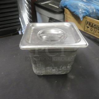1/6 Size 6 Inch Deep Hotel Pan with Lid in used condition, stainless steel, with visible wear.