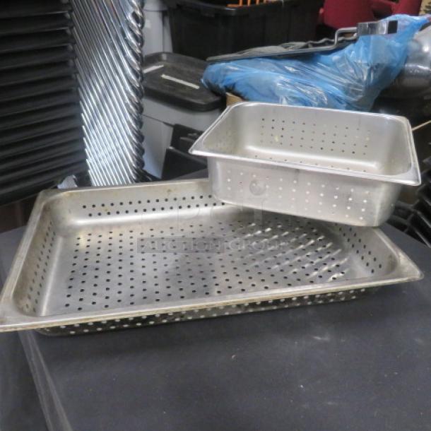 Assorted size perforated hotel pans, stainless steel, used condition, visible wear. Includes two pans, stackable design.