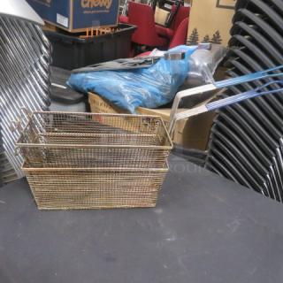 Double fry basket with long handles, metal mesh, used condition. Suitable for commercial kitchen use.