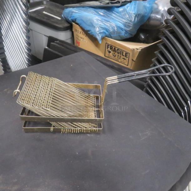 Metal deep fry basket with a long handle, in good condition, suitable for commercial use.