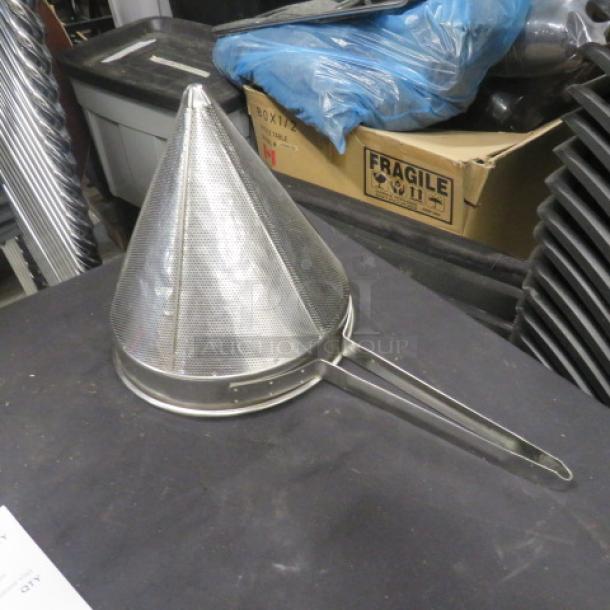Stainless steel cone strainer with handle, excellent condition, fine mesh for effective straining, durable kitchen tool.