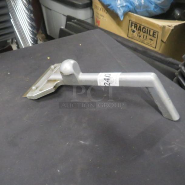 Metal griddle scraper with angled handle, light wear, auction tag number 240 visible on handle.