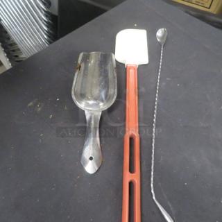 Assorted utensils including a metal scoop, a red-handled spatula, and a twisted handle spoon; fair condition.