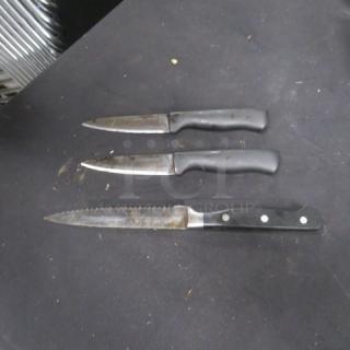Assorted chef knives, 3-piece set, black handles, serrated and straight blades, used condition, no visible brand markings.