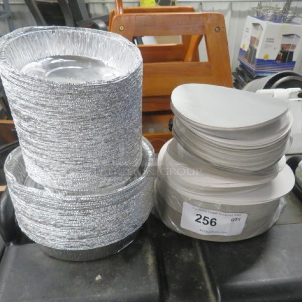 Assorted aluminum to-go plates with lids, various sizes, stacked; auction lot marked '256.'