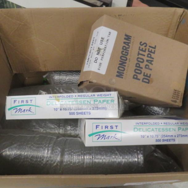 Box containing miscellaneous items including First Mark deli paper packs and Monogram paper drinking straws.