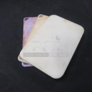 Assorted cutting boards, set of three, varying colors, gently used, visible surface wear, ideal for kitchen prep tasks.