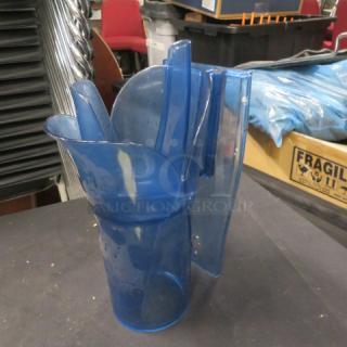 Blue plastic ice scoop, gently used, with ergonomic handle, standing upright. No visible brand markings. Suitable for bar use.