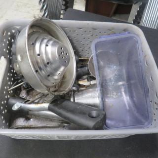 Assorted barware lot in a plastic basket, includes strainers, jigger, and muddler. Used condition, various materials.