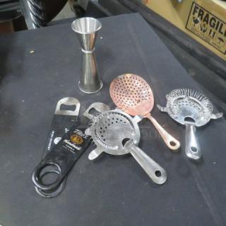 Assorted barware set including jigger, bottle openers, and strainers, featuring stainless steel and copper finishes, in good condition.