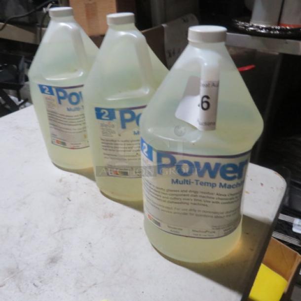 Three gallons of Power Up Multi-Temp Machine Cleaner, in clear jugs with labels detailing product use and instructions.