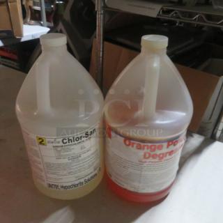 Two gallon containers of cleaner: Chlor-San Hypochlorite Solution and Orange Power Degreaser, both with visible labels.