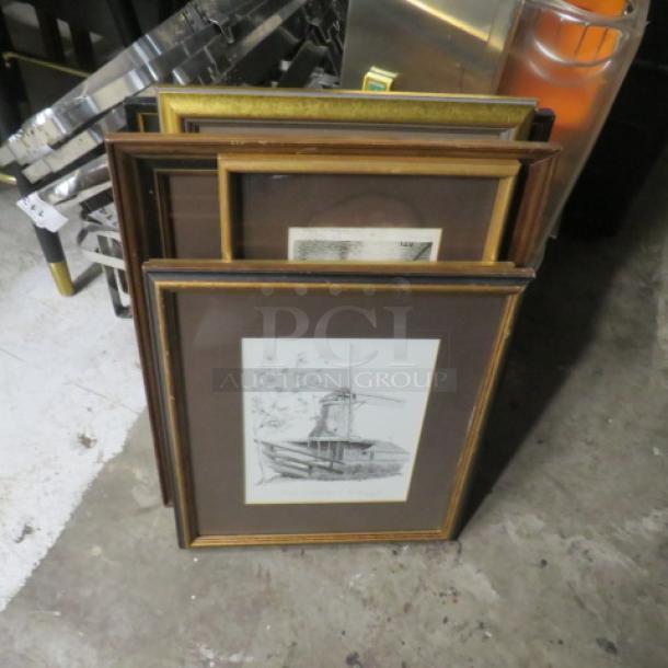One lot of assorted framed pictures in various wood frames, featuring a black and white print of a windmill. Fair condition.