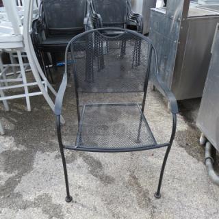 Black metal patio chair with mesh design, curved arms, and sturdy legs. Good condition, suitable for outdoor use. Model: 2XBID.