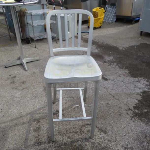 Aluminum East Coast Patio Bar Height Chair, slightly weathered, slatted back, sturdy frame, suitable for outdoor use.