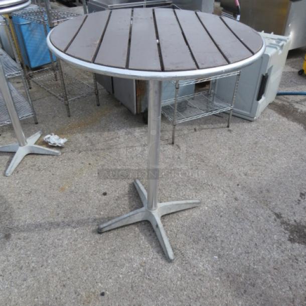 Bar height patio table, 32x42 inches, metal and wood slat top, sturdy pedestal base, used outdoor condition.