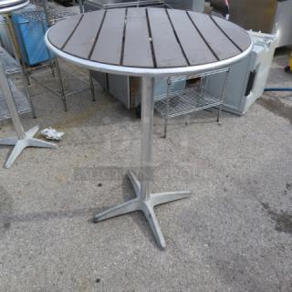 Bar height patio table, 32x42 inches, metal and wood slat top, sturdy pedestal base, used outdoor condition.