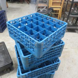 Blue 25-hole dish rack, stackable, used condition. Ideal for organizing and drying dishes. Model 4XBID.