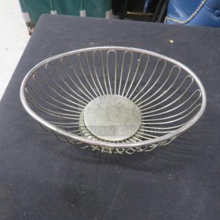 One of 27 stainless steel basket servers, wire design, round base, used condition, ideal for restaurant use.