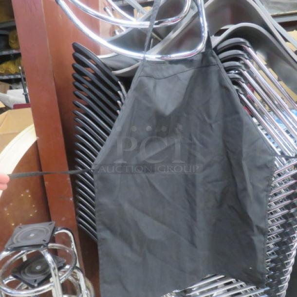 Black apron displayed, in good condition, with adjustable neck strap. No visible tags or markings. 