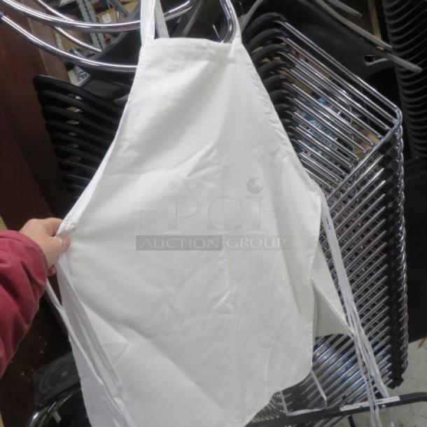 White apron, new condition, hanging on display. Plain design with neck loop and waist ties. 12XBID.