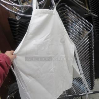 White apron, new condition, hanging on display. Plain design with neck loop and waist ties. 12XBID.