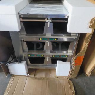 NEW Duke FWM34 Holding Cabinet with protective packaging; three compartments, stainless steel, control panels visible.